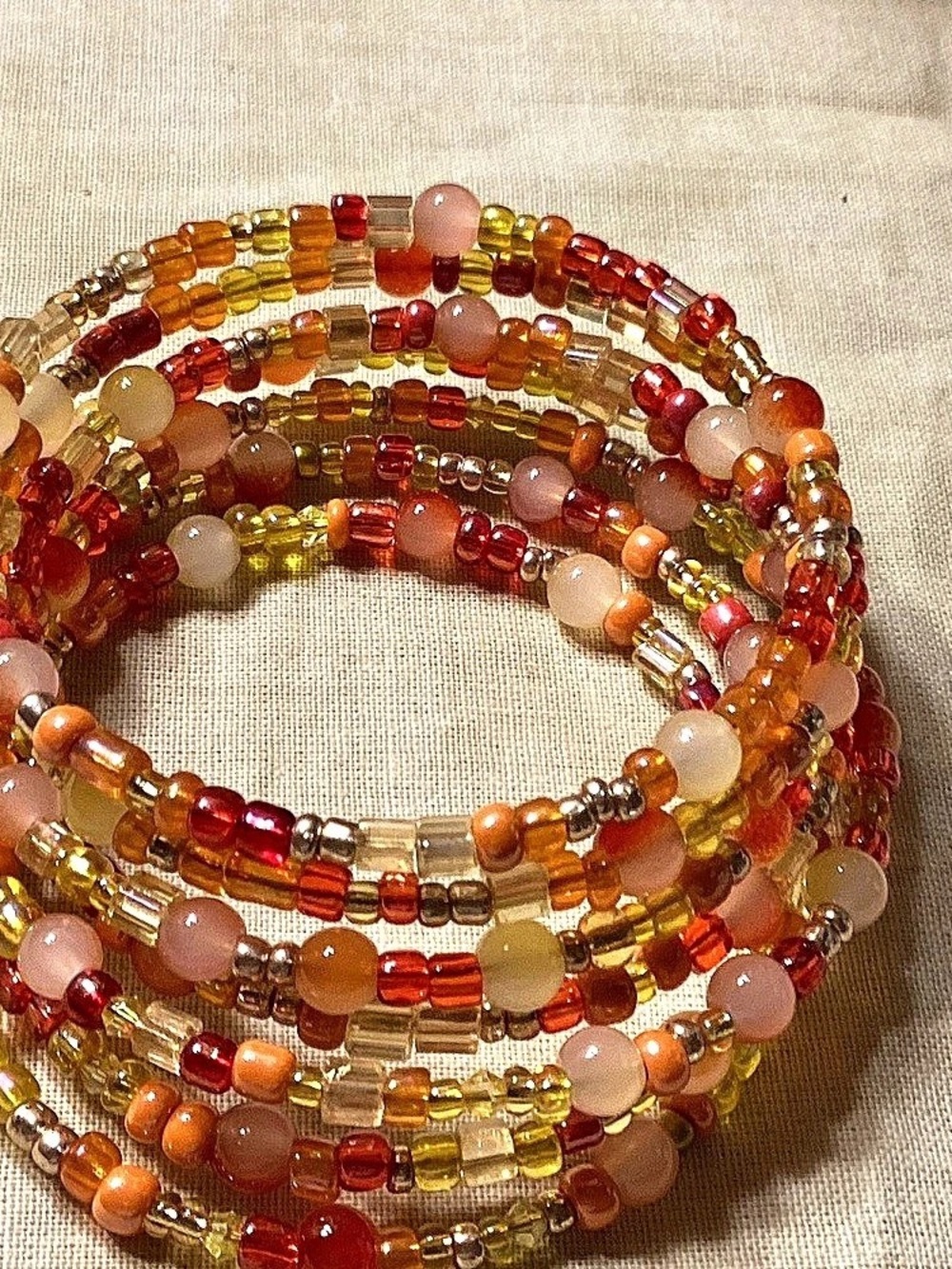 NWOT. Seven Layer Orange and Gold Beaded Memory Wire Bracelet